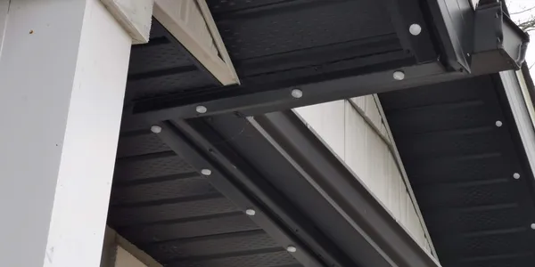 Color-matched aluminum lighting track tucked under a soffit