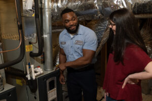 Paschal technician inspecting air handler and ductwork