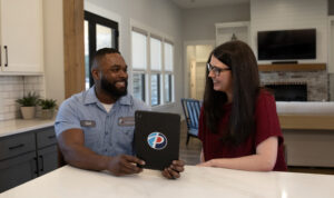 Paschal technician with homeowner after indoor air quality remediation