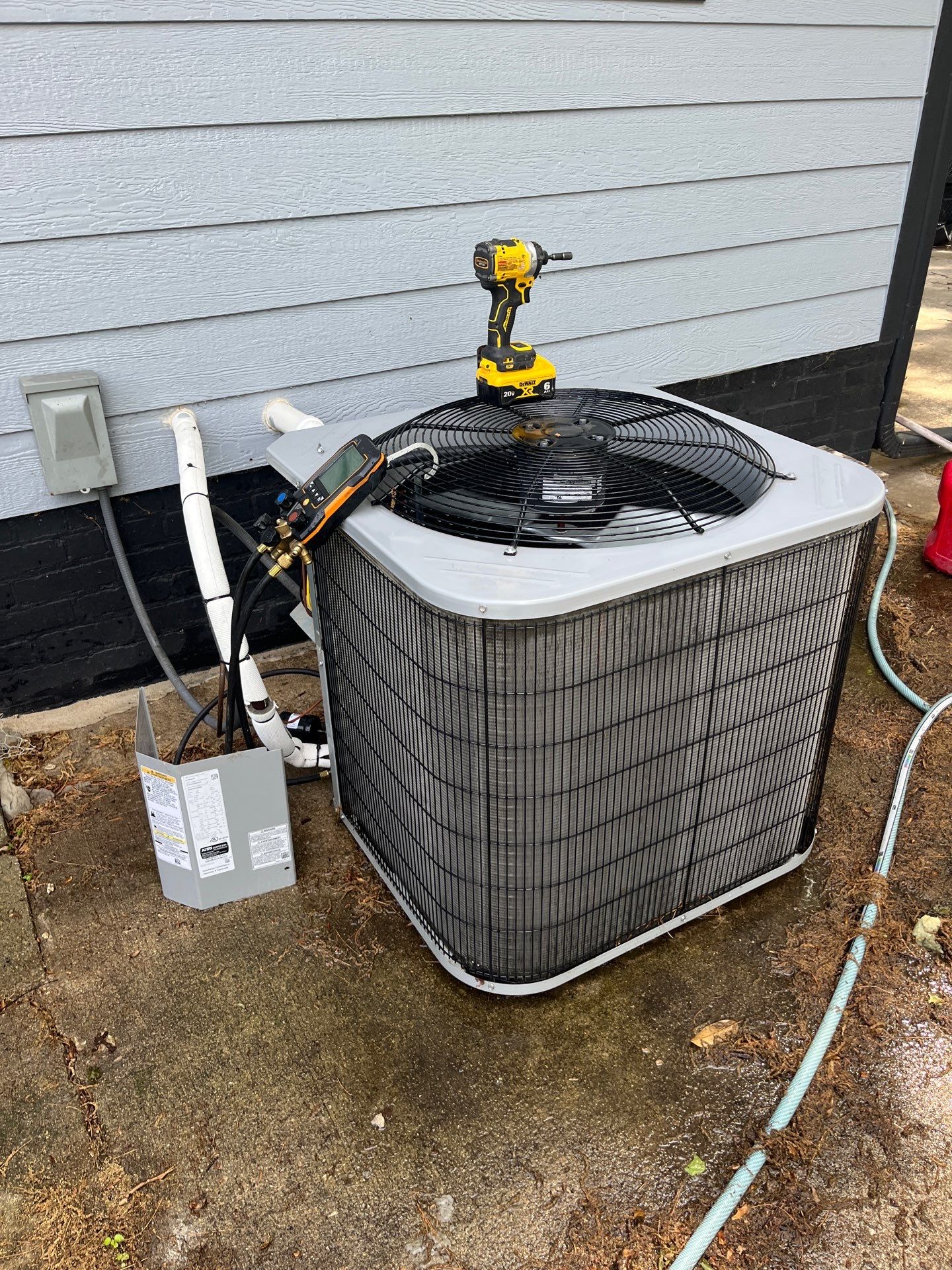 Refrigerant gauges connected to an outdoor AC unit during a Paschal HVAC tune-up in St. Joseph, MO