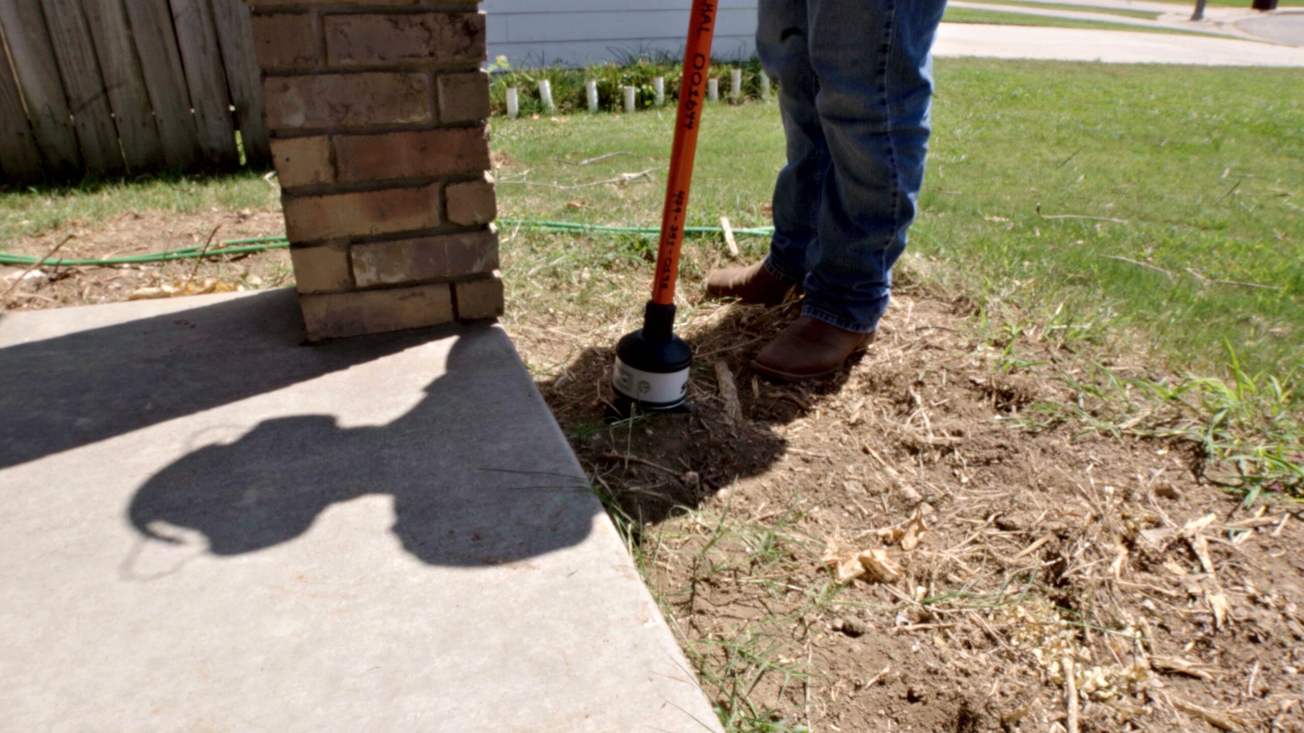 Acoustic ground sensor placed in the soil to pinpoint an underground water leak in Bentonville
